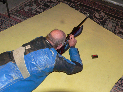 Fig 2. Showing the forward position retained with the right elbow lifted to reload the rifle. This method retains the sling tension, and allows the trigger hand to be replaced on the grip correctly before the right elbow is dropped back to the firing point. (Refer text) Modern techniques allow correct reloading while the rifle is still in place in the forward position with little chance of position disturbance.